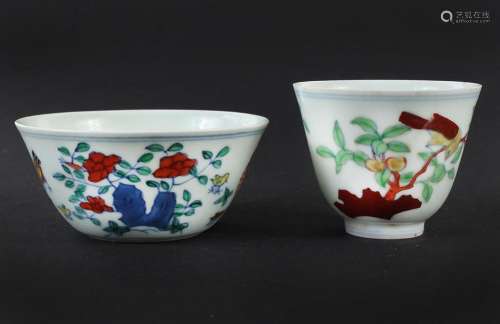 TWO SMALL DOUCAI TEACUPS - Chinese; different shapes; one decorated with rooster, hen and chicks, the second portrays a bird in a pe...