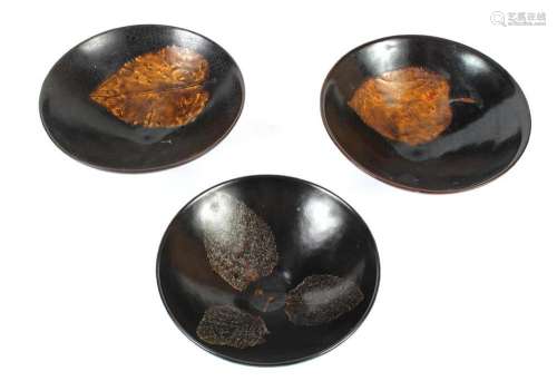 THREE CHINESE PORCELAIN BOWLS WITH LEAF IMAGE - Three Jizhou ware style tea bowls; black ground with image of one leaf or three leav...