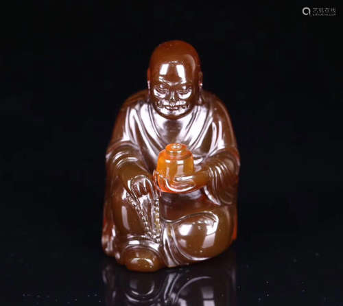 A AMBER CARVED LUOHAN FIGURE