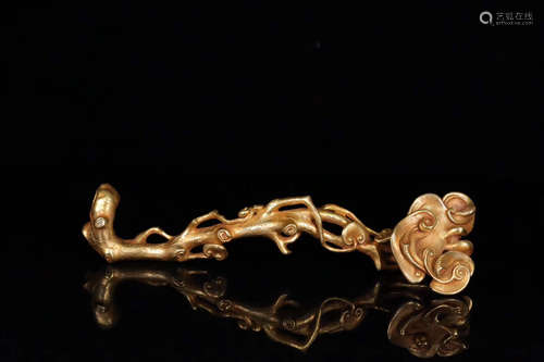 A GILT COPPER RUYI SHAPED ORNAMENT