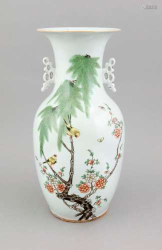 A 19th century Chinese famille rose vase, porcelain, painted with flushing plum flowers, birds, butterflies, the openwork handles with remains of gilt, H. 43 cm