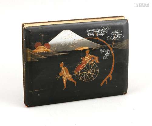 A Japanese fanfold photo album, 1st quarter 20th c., comprising coloured black-and-white photographs of women wearing kimonos as well as photographs of famous sights, the woodpanel binder with lacquer painting, lightly damaged, 15 x 19 cm