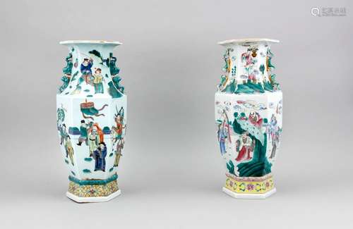 A pair of Chinese hexagonal baluster vases, 1st half 20th c., the side continuously polychromed with onglaze decor depicting a multi-figural scene, the neck with female foo-dog (with puppy) handles, raised stand ring, h. 45 cm