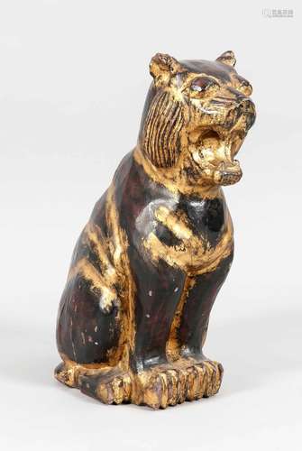 Cowering lioness, Asia, 20th c., dark asian wood, rest of gilding, minimal chipped, h. 54 cm