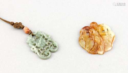 Two jade charms, one of seladon-colour with central symbol and two lizards, on darkgreen neckband with endless knot (ca. 5 x 4 cm), the other light-green with red-brown veins depicting a moth (ca. 5,5 x 5,5 cm)