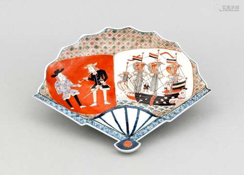 A late 19th-century Japanese Imari fan-shaped plate, decorated with Dutch merchants with hats and pipes on iron red ground, ship on the sea, the underside with cobaltblue tendrils, ca. 29 x 24 cm