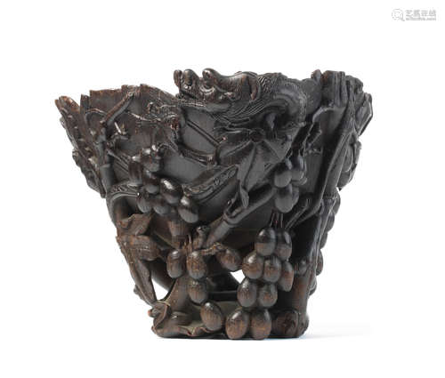 17th/18th century An exceptionally rare and very large rhinoceros horn 'three-dragons and grapevine' wine receptacle