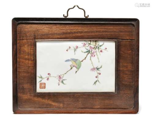 A Chinese porcelain plaque decorated in enamel colours with exotic bird on a magnolia branch in a hardwood frame.  20th century