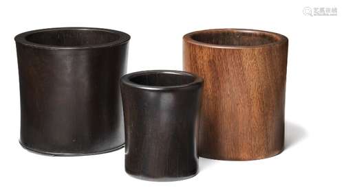 Three Chinese hardwood brush pots, bitongs. 20th century. H. 13.5–17 cm. (3)