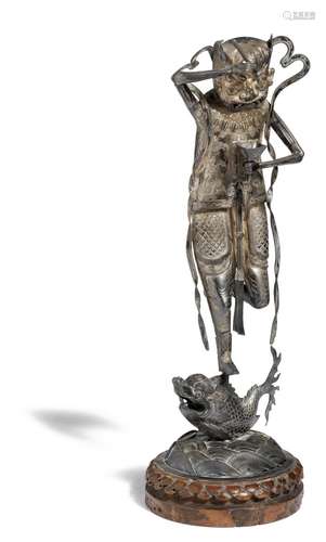 A Chinese silver figure of Kui Xing. With wooden base. C. 1900. H. excl. base 32 cm.