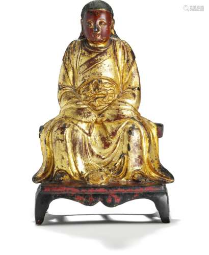 A Chinese cast, gilt, red and black painted bronze figure of seated Zhen Wu with left and right hands in mudra. Ming 1368–1644. Weight 3945 g. H. 33.5 cm.