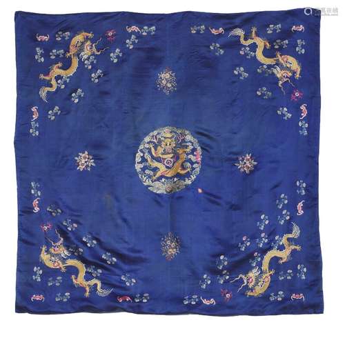 A Chinese silk embroidery. Centre rosette with yellow dragon motif on an open field with flowers and corner dragon ornaments. C. 1900. 145×143 cm.