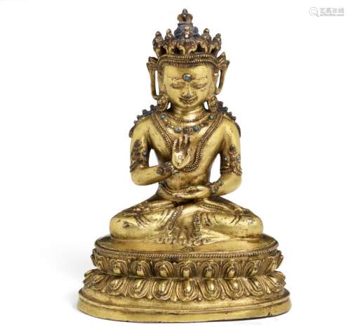 A Tibetan gilt bronze figure of Amoghasiddhi buddha. 16th-17th century. Weight 1011 g. H. 16 cm.