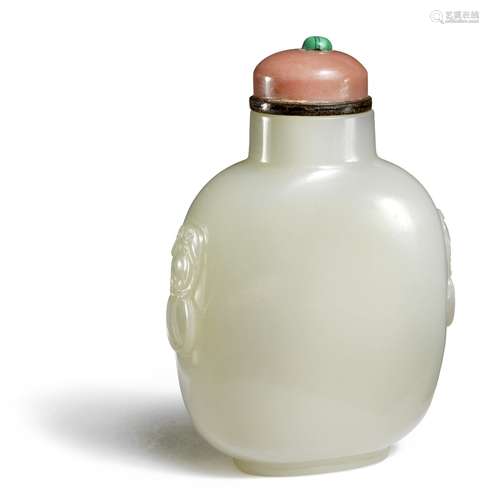 A Chinese white jade snuff bottle side carved with mask and handles, resting on an oval footrim. Stopper of pink glass on a black base with a malachite finial