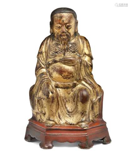 A fine bronze figure of Zhen Wu, seated on a chair. Ming,  Wanli c. 1600. Weight  2694 g. H. 26 cm.