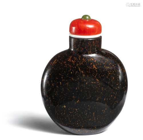 A Chinese snuff bottle of glass imitating  Fuzhou lacquer, globe shaped, resting on oval flat base, stopper of red glass with green glass finial on white base.