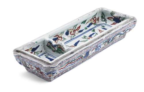 A Chinese porcelain wucai two hole writing equipment tray decorated with five clawed red dragons chaising the flaming pearl between flying phoenix. Wanli.