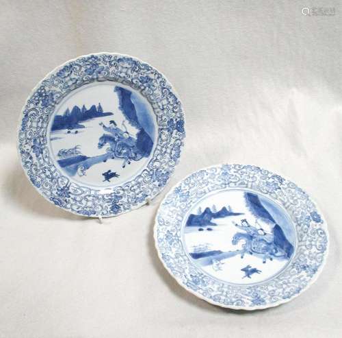 A pair of Kangxi dishes, painted with two riders hunting rabbits with bows and arrows, 23cm diameter