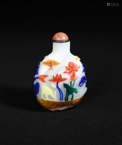 A 19th century large glass snuff bottle and stopper, carved through the translucent overlay of