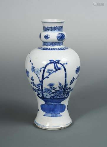 A blue and white Kangxi baluster vase, painted with baskets of flowers, the neck with a bun knop,