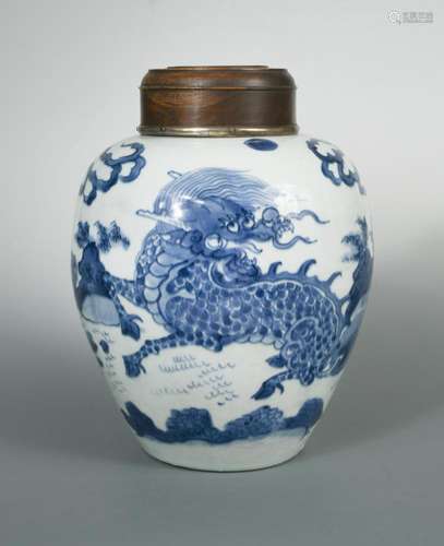 A Kangxi jar with Qilin and wood cover, the Qilin painted amongst flames, rocks and two plantains;