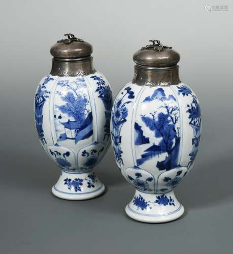 A pair of Kangxi lobed ovoid blue and white vases, with silver covers, painted with alternating