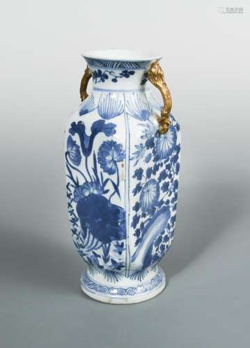 A transitional square section vase, with gilt handles, painted with panels of flowers below leaf