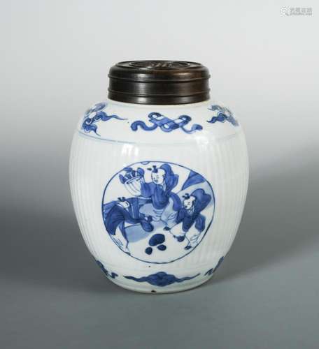 A Kangxi ribbed spherical jar and wood cover, painted with three roundels of children, 19cm high (2)