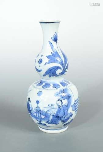 A Kangxi blue and white double gourd vase, painted with two flowers on the upper part and a seated