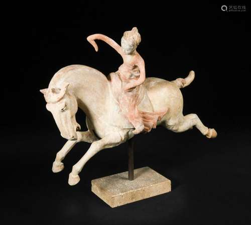 A red painted Tang dynasty pottery female polo player, astride a galloping horse, the horse