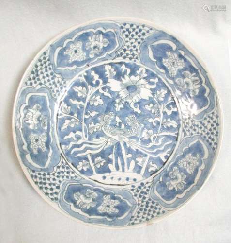 A 17th century Swatow dish, painted with a pair of phoenixes within five flower reserves on a fish