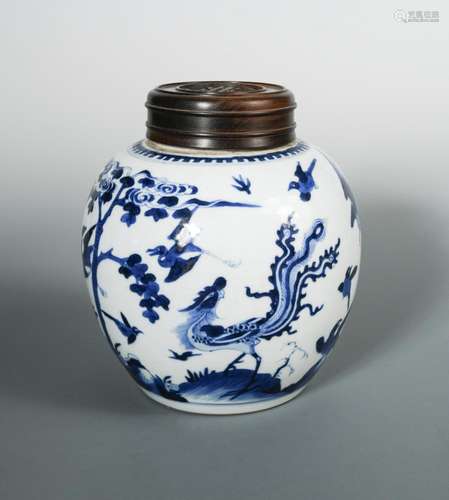 A Kangxi ovoid jar and wooden cover, painted with a phoenix and a variety of birds by a maple