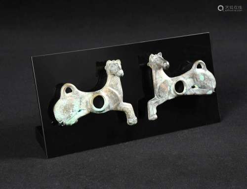A pair of Luristan horse bit plaques, 8th century BC, the galloping horse shaped plates with heads