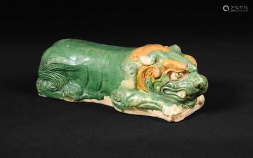 A sancai-glazed lion-form pottery pillow, Liao dynasty, the lion modelled in a recumbent position