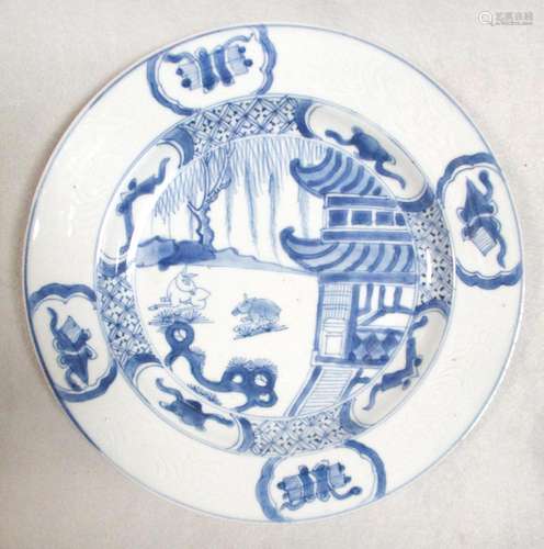 A Kangxi plate, painted with two rabbits nibbling before a pagoda, 22.5cm diameter