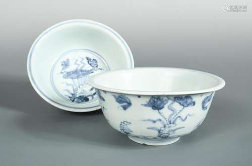 A pair of blue and white provincial Ming bowls, the exteriors painted with flowers above flame-