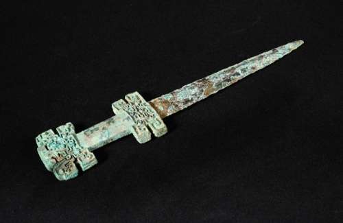 A decorated bronze dagger, late Spring and Autumn period, the handle crisply cast on each side in