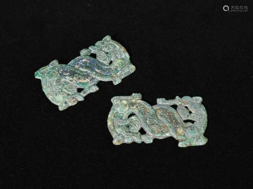A pair of bronze belt plaques, Northern China , circa 4th century B.C. depicting a dragon looking