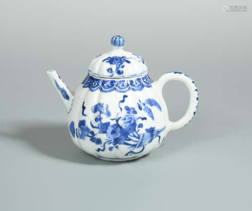 A Kangxi period lobed tea pot and cover, painted with cones of flowers below a ruyi band, 11.5cm