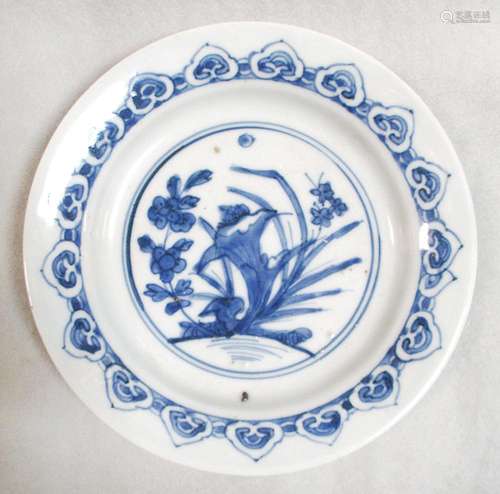 A transitional period dish, decorated with a garden roundel within ruyi lappets, 16.5cm diameter