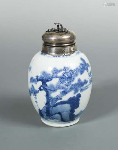 A Kangxi silver topped and mounted ovoid blue and white jar, painted with figures by rocks and a