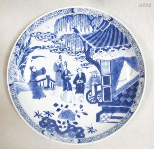 A Kangxi dish, painted with five figures outside a pavillion below a willow and clouds, 25cm