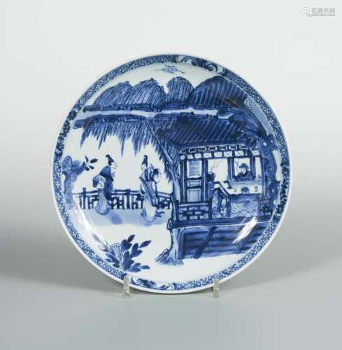 A Kangxi dish, painted with two ladies below a willow tree whilst a man is playing with a stringed