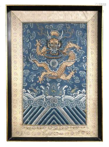 A framed embroidered Chinese textile, 19th century, (part of a robe), with five claw dragons