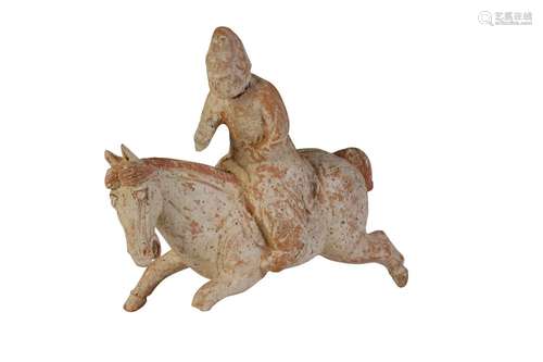 BISCUIT POTTERY FIGURE OF A POLO PLAYER, TANG DYNASTY