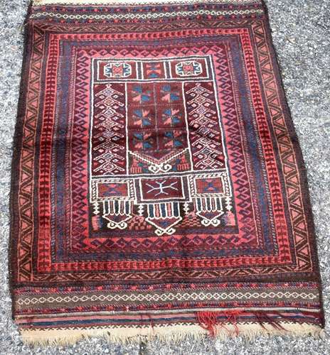 An Afghan Taimani Baluch prayer rug, circa 1920, the burgundy ground with multi borders and kelim