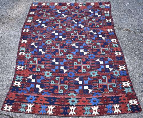 A Uzbek embroidered kilim, circa 1950, the geometric design with red and navy blue bands, 249 x