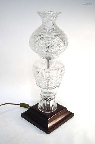 A heavy Irish Kinsale cut glass lamp base raised on a square wooden base to/w a matching lamp shade,