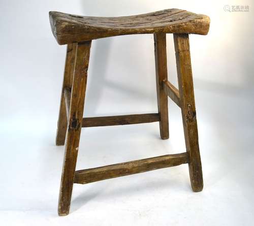 An antique 'style' rustic fruitwood joint stool, the dished plank seat on a stock frame, 43 x 23 x