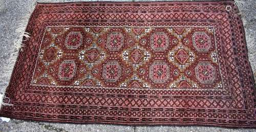 A Persian Kurd rug, Turkomen design, circa 1900, the central reserve with geometric design and